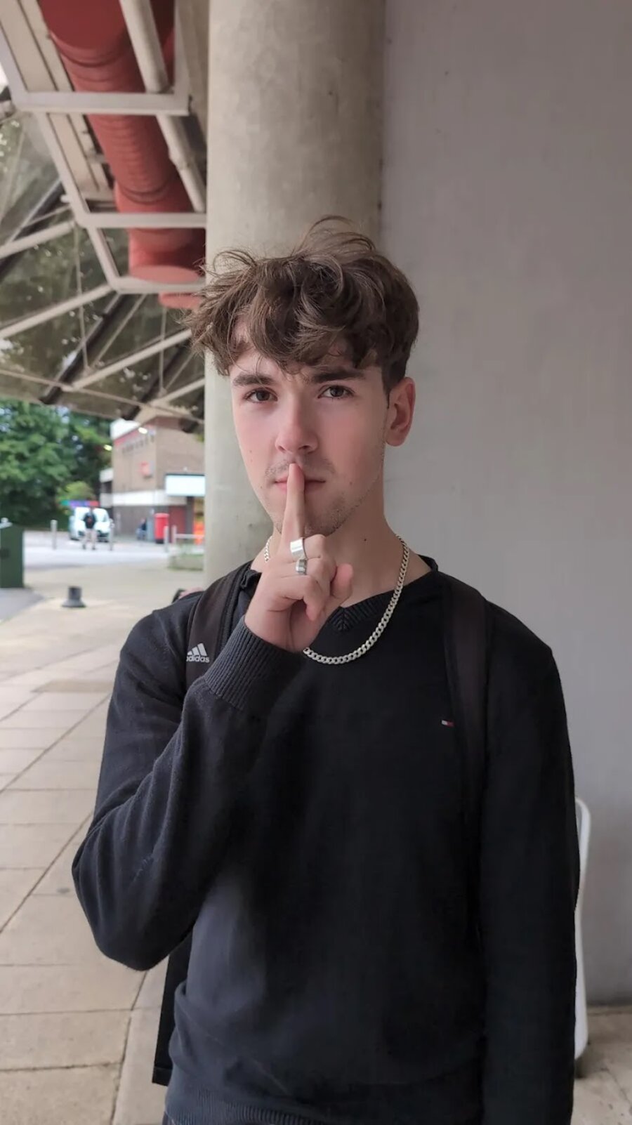 Jason holding one finger to his lips